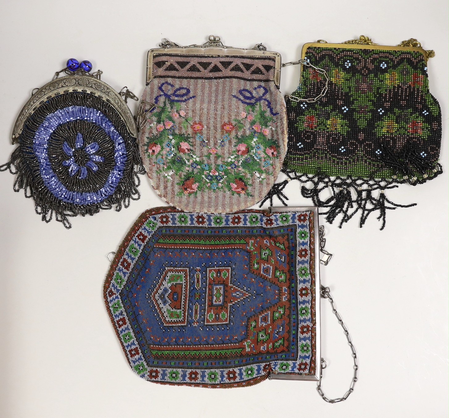 Two large metal framed Edwardian beaded bags, a later similar bead bag and a 1930’s metal framed bag with cut steel with blue beads.(4)